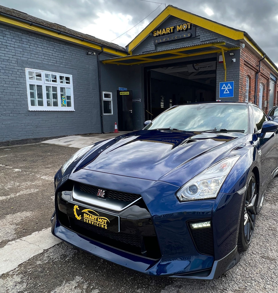 A car on the forecourt outside the Smart MOT & Servicing workshop