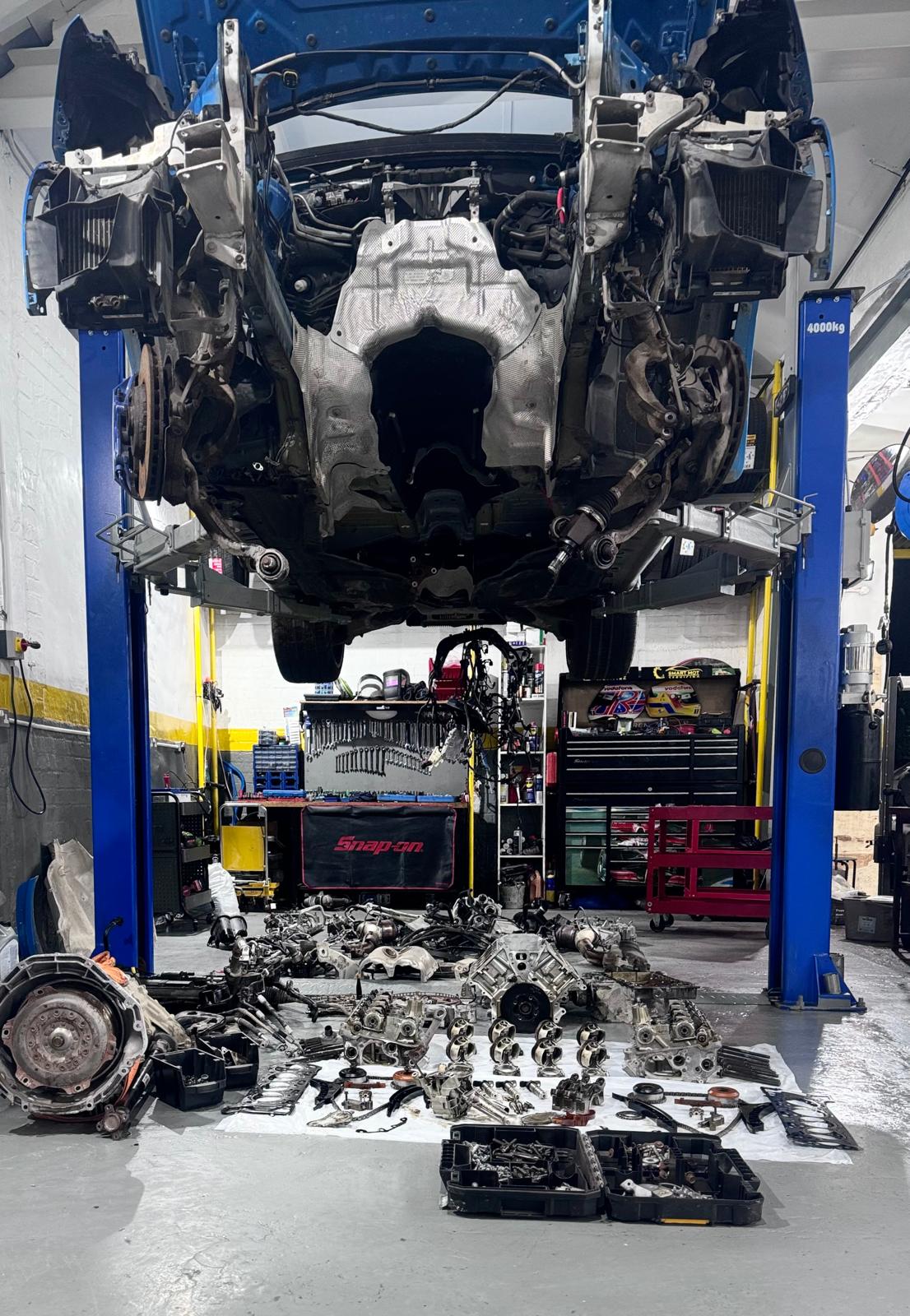 An engine and its parts laid out during a detailed strip-down and repair